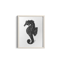 Framed artwork of a black seahorse on a white background