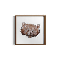Framed artwork of a red panda face on a white background